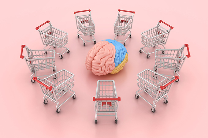 Un cerebro rosado, celeste y amarillo rodeado de 9 carritos de compras